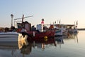 Fishing boats in a small fishing harbour at sunrise Royalty Free Stock Photo