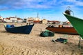 Fishing boats stranded on Aguda beach and little houses in the background