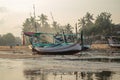 Fishing boats are stranded on the beach because sea water recedes in the morning