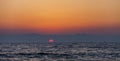 Fishing boats in sunset faraway on waves of the Indian Ocean