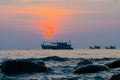 Fishing boats swimming in sea at sunset purple sky background Royalty Free Stock Photo