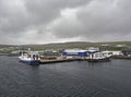 Fishing Boats tied up alongside the Shetland Catch Fish Factory Quay on a rainy wet August day in the Shetland Islands.