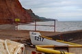 Fishing boats tied up on the jetty at Sidmouth in Devon, England. The River Sid and the red Jurassic cliffs can be seen in the