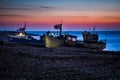 Fishing boats waiting to be launched from Hastings beach before dawn.