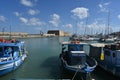 Fishing boats with white and blue wooden hulls in Greek port of Heraklion.