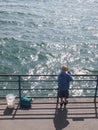 Fishing boy on a pier Royalty Free Stock Photo
