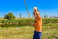 A fishing boy on a river holds a fishing rod, a child caught a fish and pulls it out of the water on a hook Royalty Free Stock Photo