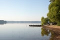 Fishing bridge on the shore of a forest lake in the early morning in the fog Royalty Free Stock Photo