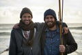 Fishing buddies. Portrait of two young fishermen in the early morning. Royalty Free Stock Photo