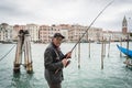 Fishing by Canal Grande in Venice