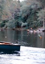 Fishing in a canoe in autumn in maine