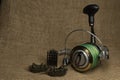 Fishing, carp reel with fishing linel on the background of burlap . Burlap