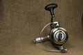 Fishing, carp reel with fishing linel on the background of burlap . Burlap