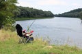 Fishing chair, rod and bait on the river bank Royalty Free Stock Photo