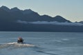 A fishing charter boat heads out from Seward Harbor Royalty Free Stock Photo