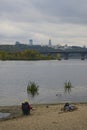 Fishing in comfort. Man sits in a folding chair and fishes on the bank of the Dnipro river in Kyiv. Cloudy autumn day Royalty Free Stock Photo