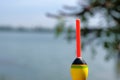 Fishing concept. Bobber on the background of the river close-up Royalty Free Stock Photo