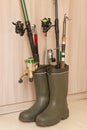 Fishing concept: rubber boots and fishing rods