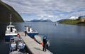 Fishing from dock in fjord Royalty Free Stock Photo