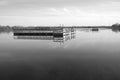 Fishing dock floating in the lake in black and white