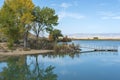 Fishing Dock Juts into a Still Lake with Reflections