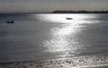 Fishing at dusk - Two boats traveling in opposite directions with bokeh light spilling across the water from the moon making the w Royalty Free Stock Photo