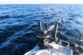 Fishing equipment on boat. Downrigger boat gear for trolling.  Fishing boat with down rigger trolling in blue ocean. Fisherman Royalty Free Stock Photo