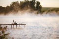 Fishing equipment on pier on lake. Feeder carp rods on wooden pier Royalty Free Stock Photo