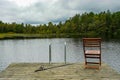 Fishing equipment on seat on lake. Feeder carp rods on wooden pier Royalty Free Stock Photo