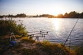 Fishing equipment on seat on lake. Feeder carp rods on sunrise Royalty Free Stock Photo