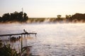 Fishing equipment on seat on lake. Feeder carp rods on wooden pier Royalty Free Stock Photo