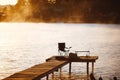 Fishing equipment on seat on lake. Feeder carp rods on wooden pier Royalty Free Stock Photo