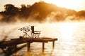 Fishing equipment on seat on lake. Feeder carp rods on wooden pier Royalty Free Stock Photo