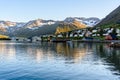 Fishing fillage in a narrow fjord and reflecion in water Royalty Free Stock Photo