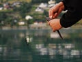 Fishing. A fisherman catches a fish and pulls the bait - hook out of its mouth. North Sea, fjord, Norway, Scandinavia. Catching