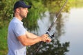 Fishing. Fisherman on river with fishing rod. Outdoor fishing in lake during sunset. Hunting and hobby