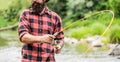 Fishing. Fisherman and trout. Fly Fishing Time. Fisherman with Fishing Rod on the Lake Shore. Fishing rod lake fisherman Royalty Free Stock Photo