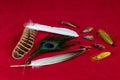 Fishing Flies and Assorted Fly Tying Feathers on a Red Table Cloth Royalty Free Stock Photo