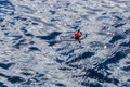 A fishing float bobber floating in the water surface Royalty Free Stock Photo