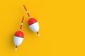 Fishing floats on orange background. Accessories for hobby and leisure