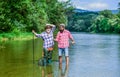 Fishing freshwater lake pond river. Mature man with friend fishing. Summer vacation. Bearded men catching fish. Family Royalty Free Stock Photo