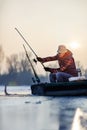 Fishing on frozen lake- Happy fisherman catch fish Royalty Free Stock Photo