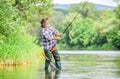 Fishing is fun. mature man fly fishing. man catching fish. summer weekend. Big game fishing. retired bearded fisher Royalty Free Stock Photo