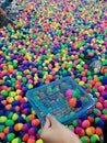 Fishing game with colored floating egg to fish with a dip net