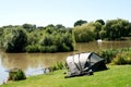 Fishing gear & tent beside lake