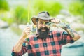 Fishing hobby and summer weekend. Funny bearded men fisher with fishing rod and net. Fish eye fun.