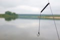 Fishing hook on water and fishes on the river