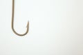 Fishing hook on a white paper background Royalty Free Stock Photo