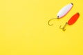 Fishing hooks and baits in a set for catching different fish on a yellow background with copy space. Flat lay Royalty Free Stock Photo