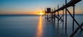 A fishing hut called carrelet with craft lifting net at sunset. Esnandes, charente maritime, France. The sun is caught in the net